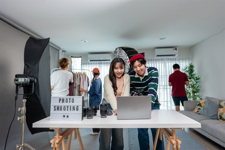 Behind the scenes of film crew collaborate on set under director's guidance. Attractive young director work with team to create movies, advertisements, TV series using filming techniques in studio.